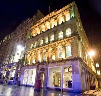 Former Teacher building Glasgow St Enoch Square lighting at night