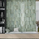 A bedroom with sage-green subtile backdrop and couch
