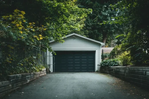 home garage door drive wooded garden
