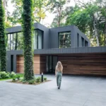 house merged in forest in Poland - why aluminium windows work in modern and period homes