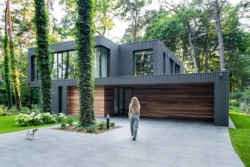 house merged in forest in Poland - why aluminium windows work in modern and period homes