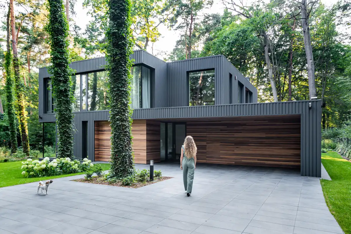 house merged in forest in Poland - why aluminium windows work in modern and period homes
